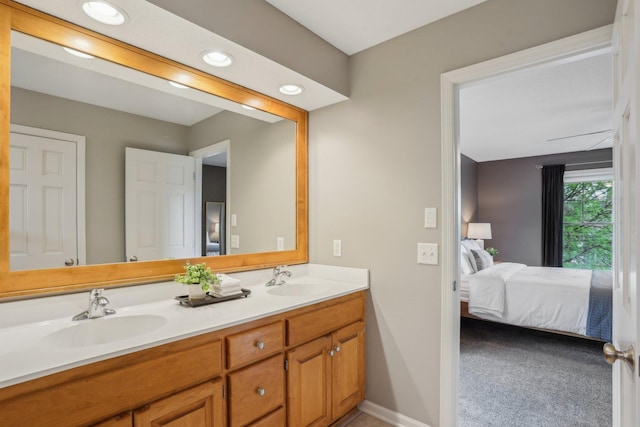 11560 Ashley Ct, Inver Grove Heights, MN 55077 - full bathroom with ensuite bath, double vanity, recessed lighting, and baseboards