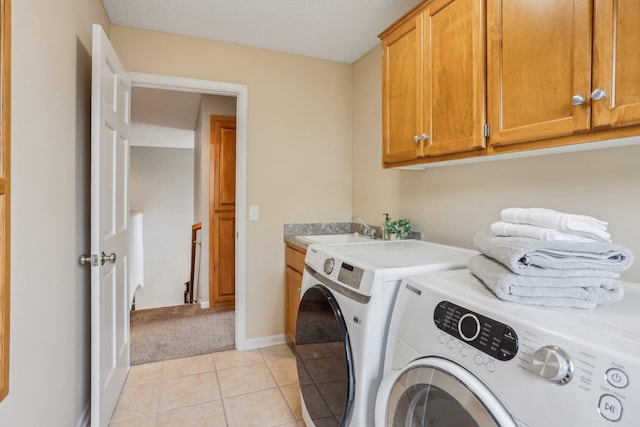 11560 Ashley Ct, Inver Grove Heights, MN 55077 - laundry room with washer and dryer, cabinet space, light tile patterned floors, light colored carpet, and baseboards