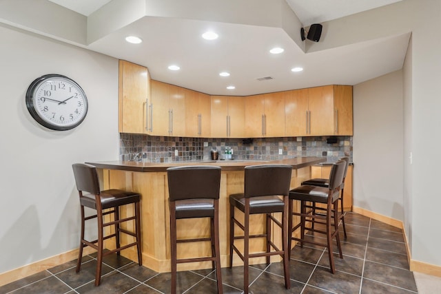 11560 Ashley Ct, Inver Grove Heights, MN 55077 - bar area featuring backsplash, dark tile patterned flooring, recessed lighting, and baseboards