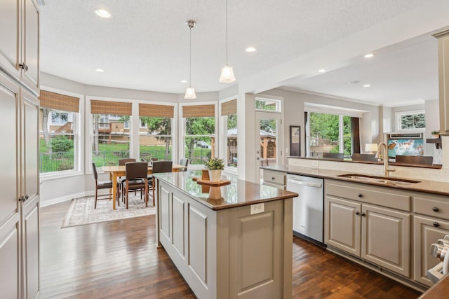 11560 Ashley Ct, Eagan, MN 55077 - kitchen with dishwashing machine, light stone countertops, dark wood finished floors, a center island, and recessed lighting