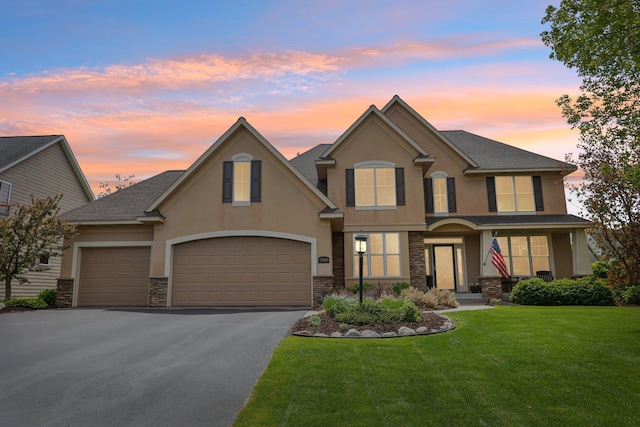 11560 Ashley Ct, Eagan, MN 55077 - view of front of property with stucco siding, stone siding, driveway, and a front lawn