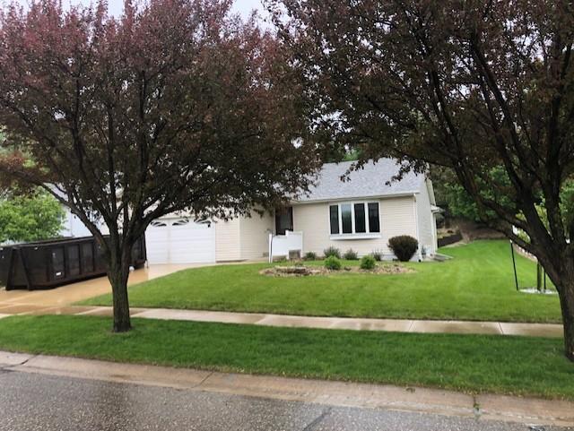 2023 Woodcrest Ln SW, Rochester, MN 55902 - single story home with driveway, an attached garage, and a front lawn