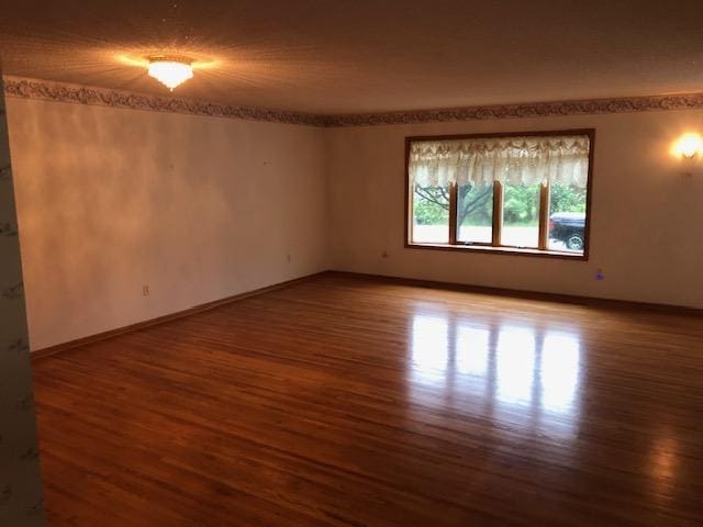 2023 Woodcrest Ln SW, Rochester, MN 55902 - spare room featuring wood finished floors and baseboards