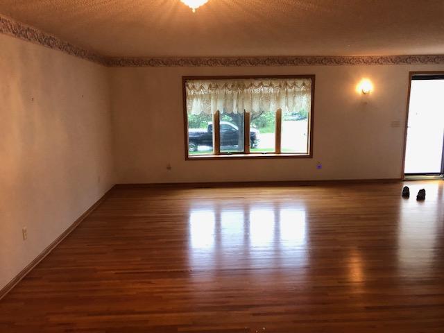 2023 Woodcrest Ln SW, Rochester, MN 55902 - unfurnished room with wood finished floors and baseboards