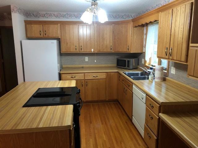2023 Woodcrest Ln SW, Rochester, MN 55902 - kitchen featuring white appliances, a sink, wood counters, and light wood finished floors
