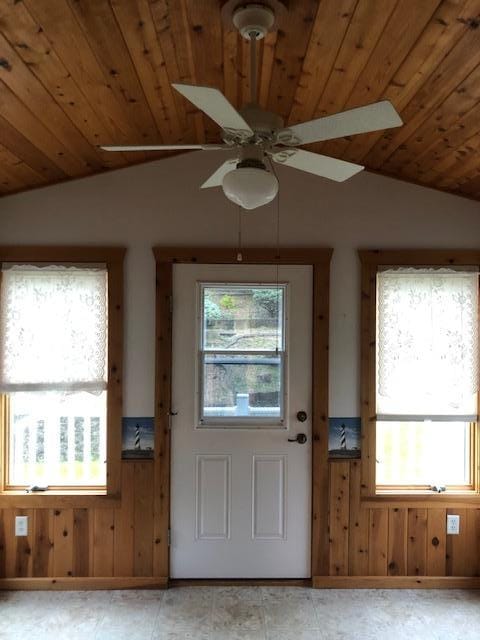 2023 Woodcrest Ln SW, Rochester, MN 55902 - entryway featuring lofted ceiling, wooden ceiling, wooden walls, and a ceiling fan