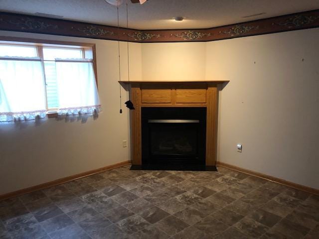 2023 Woodcrest Ln SW, Rochester, MN 55902 - detailed view of a fireplace with flush hearth, baseboards, and ceiling fan