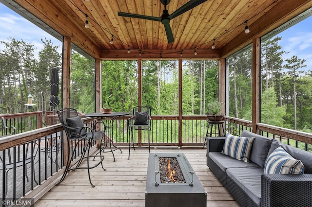 7023 61st St S, Cottage Grove, MN 55016 - sunroom with ceiling fan, rail lighting, an outdoor living space with a fire pit, and view of scattered trees