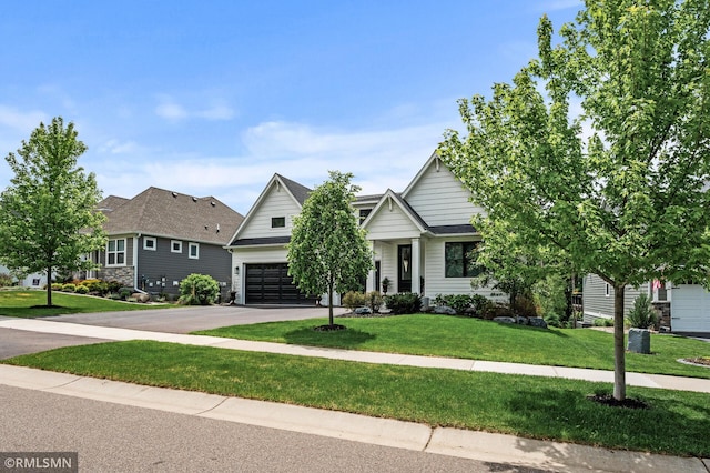 7023 61st St S, Cottage Grove, MN 55016 - obstructed view of property featuring a garage, driveway, and a front lawn