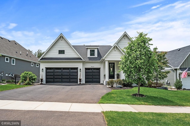 7023 61st St S, Cottage Grove, MN 55016 - view of front of property featuring driveway, a front lawn, a shingled roof, and an attached garage