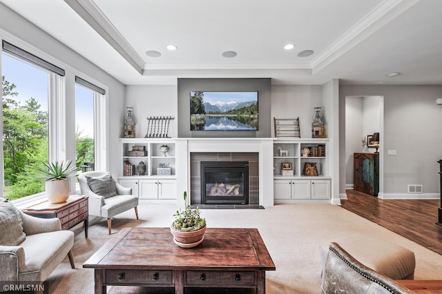7023 61st St S, Cottage Grove, MN 55016 - living area with a raised ceiling, ornamental molding, a fireplace with flush hearth, wood finished floors, and baseboards