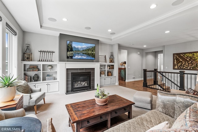 7023 61st St S, Cottage Grove, MN 55016 - living room with recessed lighting, a tray ceiling, ornamental molding, a tile fireplace, and wood finished floors
