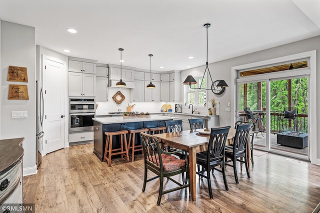 7023 61st St S, Cottage Grove, MN 55016 - dining area featuring light wood-style floors, recessed lighting, and baseboards