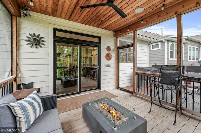 7023 61st St S, Cottage Grove, MN 55016 - wooden terrace featuring an outdoor fire pit, a ceiling fan, and outdoor dining space