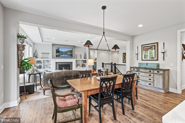 7023 61st St S, Cottage Grove, MN 55016 - dining space featuring baseboards, light wood-style flooring, a fireplace, and recessed lighting