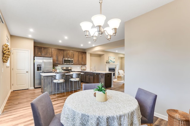 2189 Gateway Hill Rd N, Saint Paul, MN 55109 - dining area featuring light wood-style flooring, a chandelier, baseboards, and recessed lighting