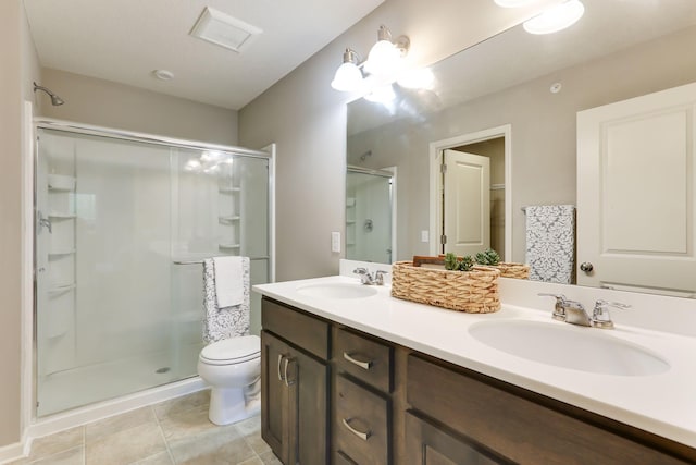 2189 Gateway Hill Rd N, Saint Paul, MN 55109 - full bathroom with a shower stall, double vanity, toilet, and tile patterned flooring