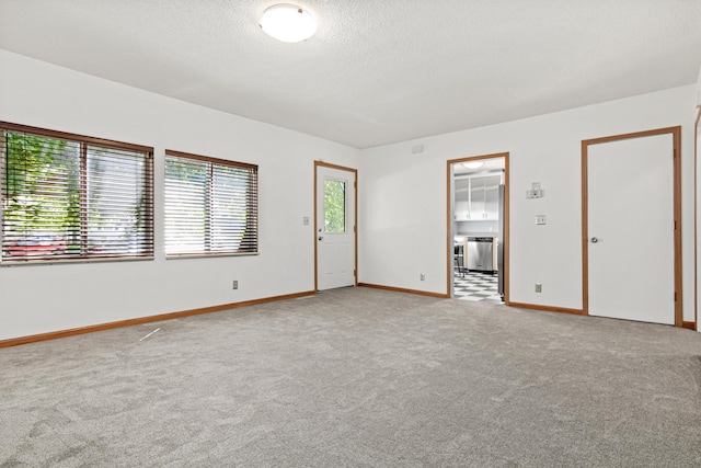 3372 Texas Ave S, Saint Louis Park, MN 55426 - unfurnished room with carpet flooring, a textured ceiling, and baseboards