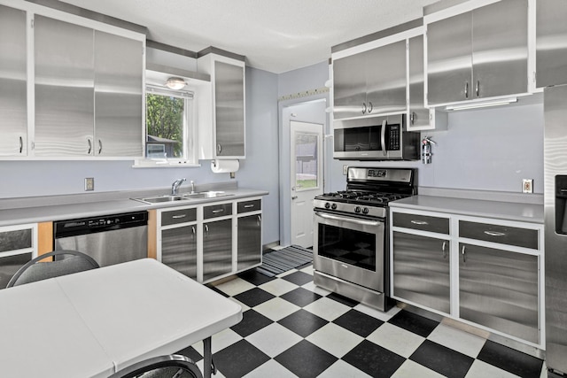3372 Texas Ave S, Saint Louis Park, MN 55426 - kitchen with stainless steel appliances, a sink, light floors, and light countertops