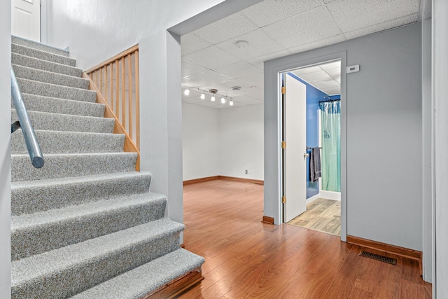 3372 Texas Ave S, Saint Louis Park, MN 55426 - staircase featuring a drop ceiling, baseboards, and wood finished floors