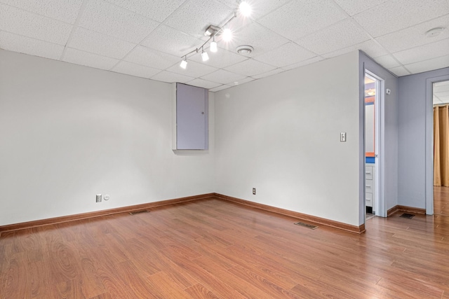 3372 Texas Ave S, Saint Louis Park, MN 55426 - empty room with a drop ceiling, wood finished floors, and baseboards