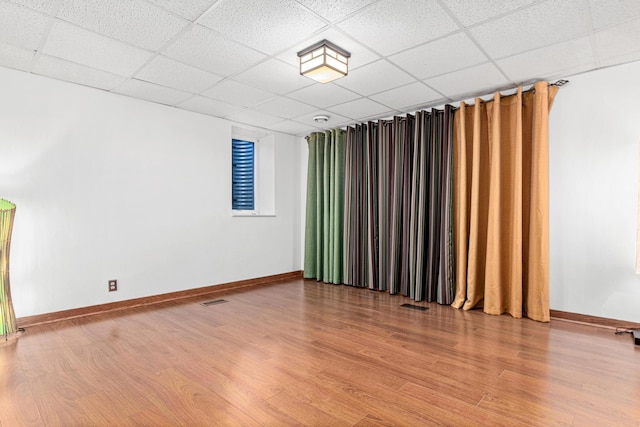 3372 Texas Ave S, Saint Louis Park, MN 55426 - spare room featuring a paneled ceiling, light wood-style floors, and baseboards