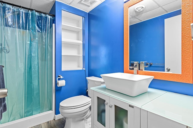 3372 Texas Ave S, Saint Louis Park, MN 55426 - bathroom featuring a paneled ceiling, toilet, vanity, a shower with shower curtain, and wood finished floors