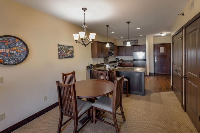 502 Cleveland Blvd W Unit 2400, Walker, MN 56484 - dining room with baseboards, a chandelier, recessed lighting, and light colored carpet