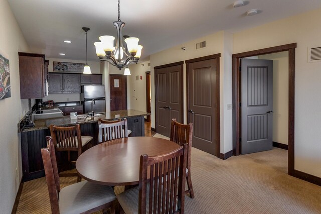 502 Cleveland Blvd W Unit 2400, Walker, MN 56484 - dining area with a chandelier, light carpet, baseboards, and recessed lighting