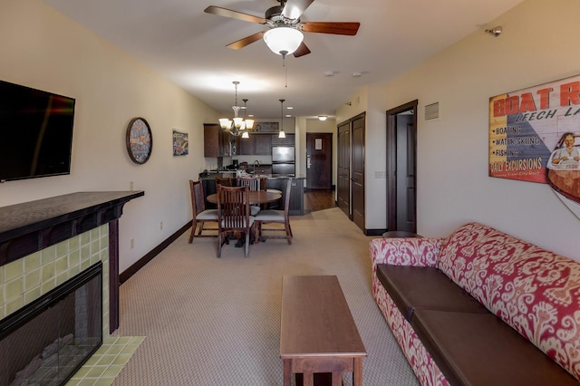 502 Cleveland Blvd W Unit 2400, Walker, MN 56484 - living area featuring a chandelier, light carpet, a tiled fireplace, ceiling fan, and baseboards