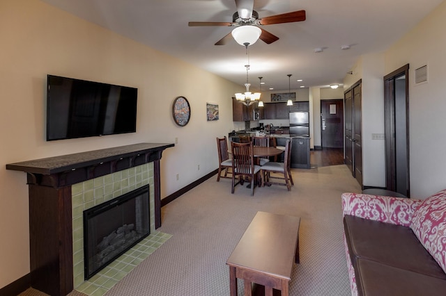 502 Cleveland Blvd W Unit 2400, Walker, MN 56484 - living room with a fireplace, baseboards, ceiling fan, a chandelier, and light colored carpet
