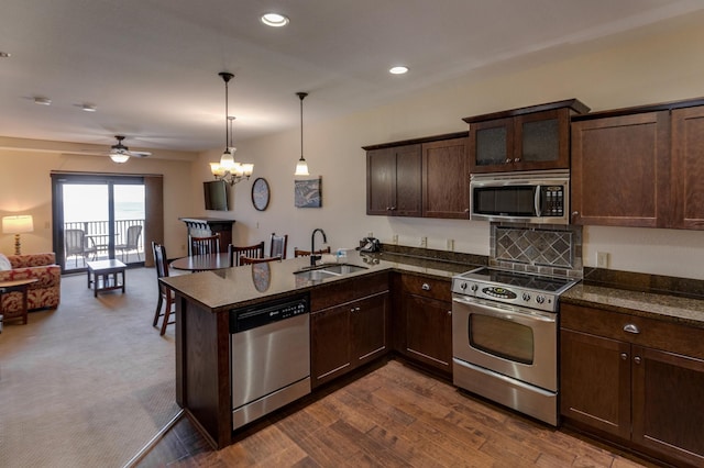 502 Cleveland Blvd W Unit 2400, Walker, MN 56484 - kitchen with stainless steel appliances, a sink, dark brown cabinets, ceiling fan, and open floor plan