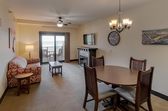 502 Cleveland Blvd W Unit 2400, Walker, MN 56484 - carpeted dining space with ceiling fan, baseboards, a fireplace, and a chandelier