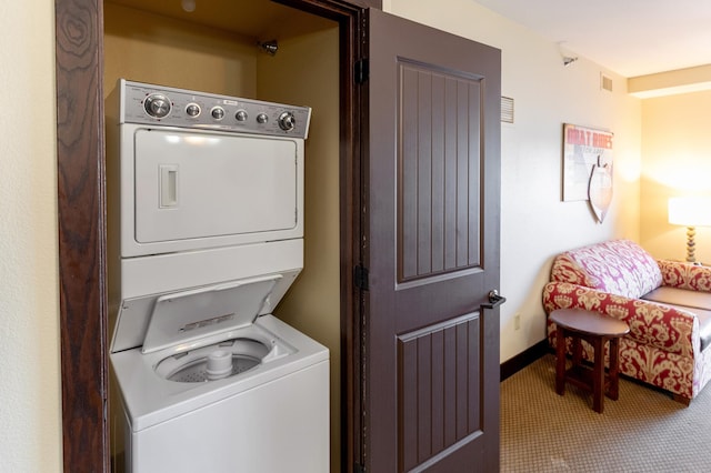 502 Cleveland Blvd W Unit 2400, Walker, MN 56484 - washroom with stacked washing machine and dryer, baseboards, and carpet flooring