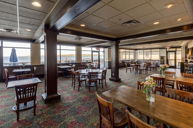 502 Cleveland Blvd W Unit 2400, Walker, MN 56484 - carpeted dining space featuring decorative columns and a water view