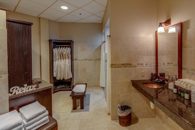 502 Cleveland Blvd W Unit 2400, Walker, MN 56484 - full bath with tile walls, a sink, tile patterned flooring, and a paneled ceiling