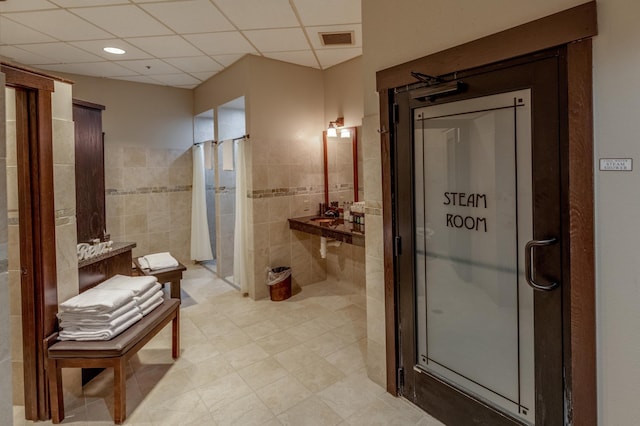 502 Cleveland Blvd W Unit 2400, Walker, MN 56484 - full bath with a shower stall, tile walls, a paneled ceiling, and tile patterned flooring
