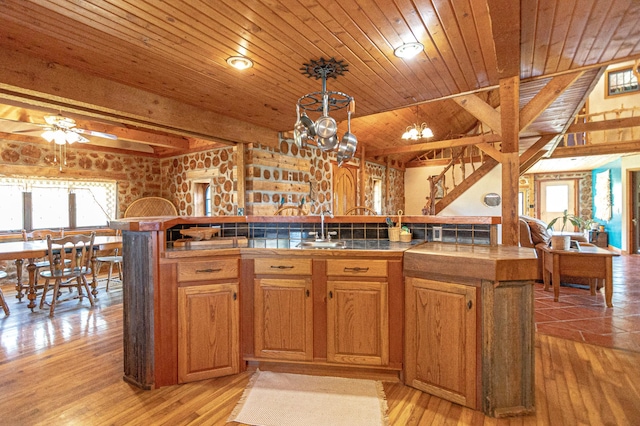 12926 Daisy Ln SW, Farwell, MN 56327 - kitchen with tile countertops, plenty of natural light, wooden ceiling with exposed beams, a sink, and light wood finished floors