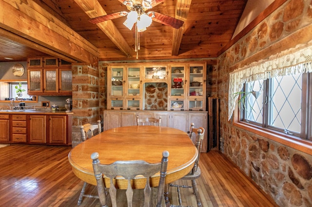 12926 Daisy Ln SW, Farwell, MN 56327 - dining space with wood ceiling with exposed beams, light wood-style flooring, a ceiling fan, and rustic walls