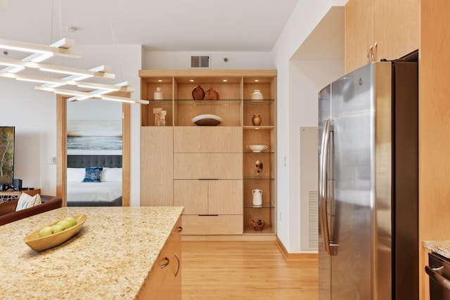 1240 2nd St Unit 822, Minneapolis, MN 55415 - kitchen featuring appliances with stainless steel finishes, light wood finished floors, light stone counters, and modern cabinets