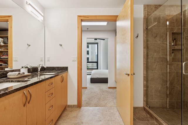 1240 2nd St Unit 822, Minneapolis, MN 55415 - ensuite bathroom featuring double vanity, a shower stall, and baseboards