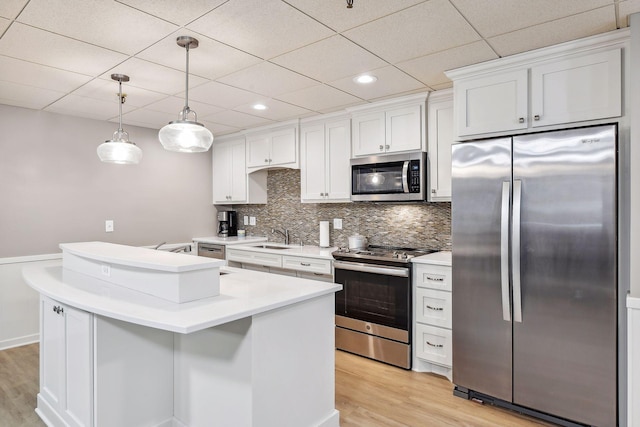 4360 Brookside Ct Unit 305, Edina, MN 55436 - kitchen with appliances with stainless steel finishes, light wood-style flooring, backsplash, white cabinetry, and a paneled ceiling