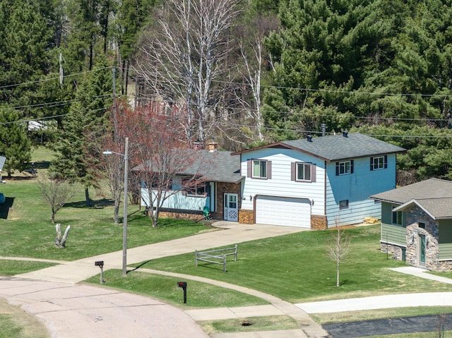 22 Cottonwood Ct, Babbitt, MN 55706 - view of front of home with a garage, concrete driveway, a front yard, and brick siding