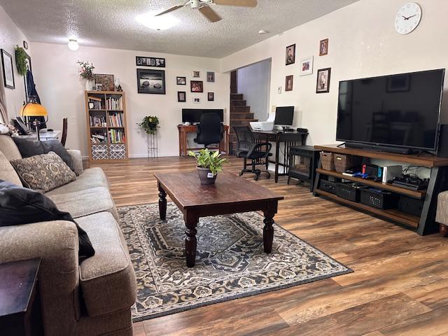 22 Cottonwood Ct, Babbitt, MN 55706 - living area with a textured ceiling, a ceiling fan, wood finished floors, and stairs