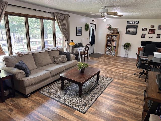 22 Cottonwood Ct, Babbitt, MN 55706 - living area featuring a desk, a textured ceiling, a ceiling fan, wood finished floors, and baseboards