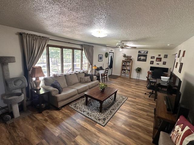 22 Cottonwood Ct, Babbitt, MN 55706 - living room featuring a textured ceiling, wood finished floors, a desk, and a ceiling fan