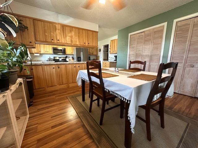 22 Cottonwood Ct, Babbitt, MN 55706 - dining space with wood finished floors, a textured ceiling, and ceiling fan