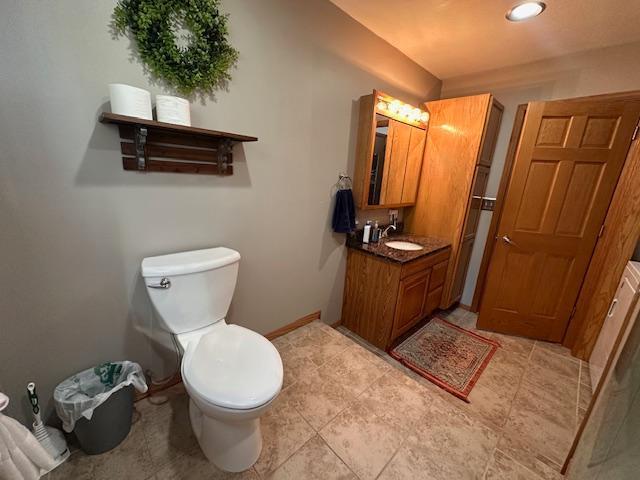 22 Cottonwood Ct, Babbitt, MN 55706 - bathroom with toilet, vanity, baseboards, and recessed lighting
