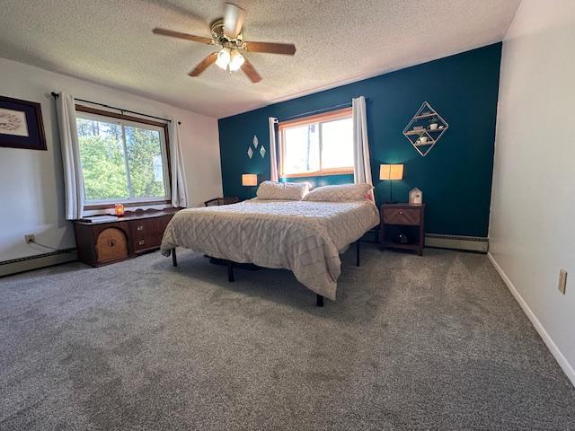22 Cottonwood Ct, Babbitt, MN 55706 - bedroom featuring a textured ceiling, multiple windows, carpet flooring, a ceiling fan, and a baseboard radiator