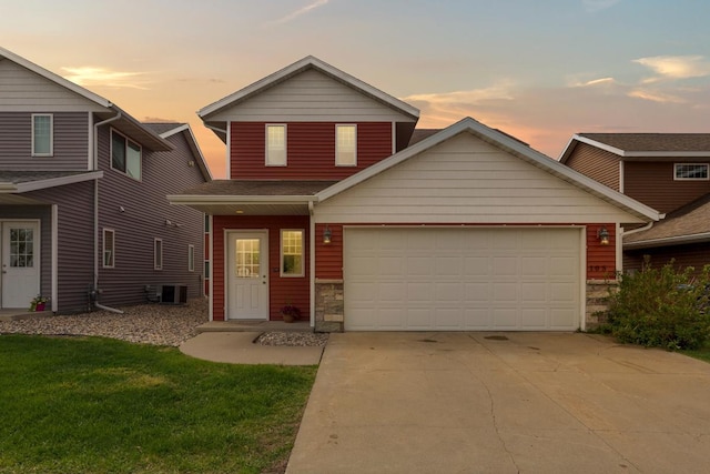 105 Owl Path, Mankato, MN 56001 - traditional-style home featuring concrete driveway, a garage, stone siding, a yard, and central AC